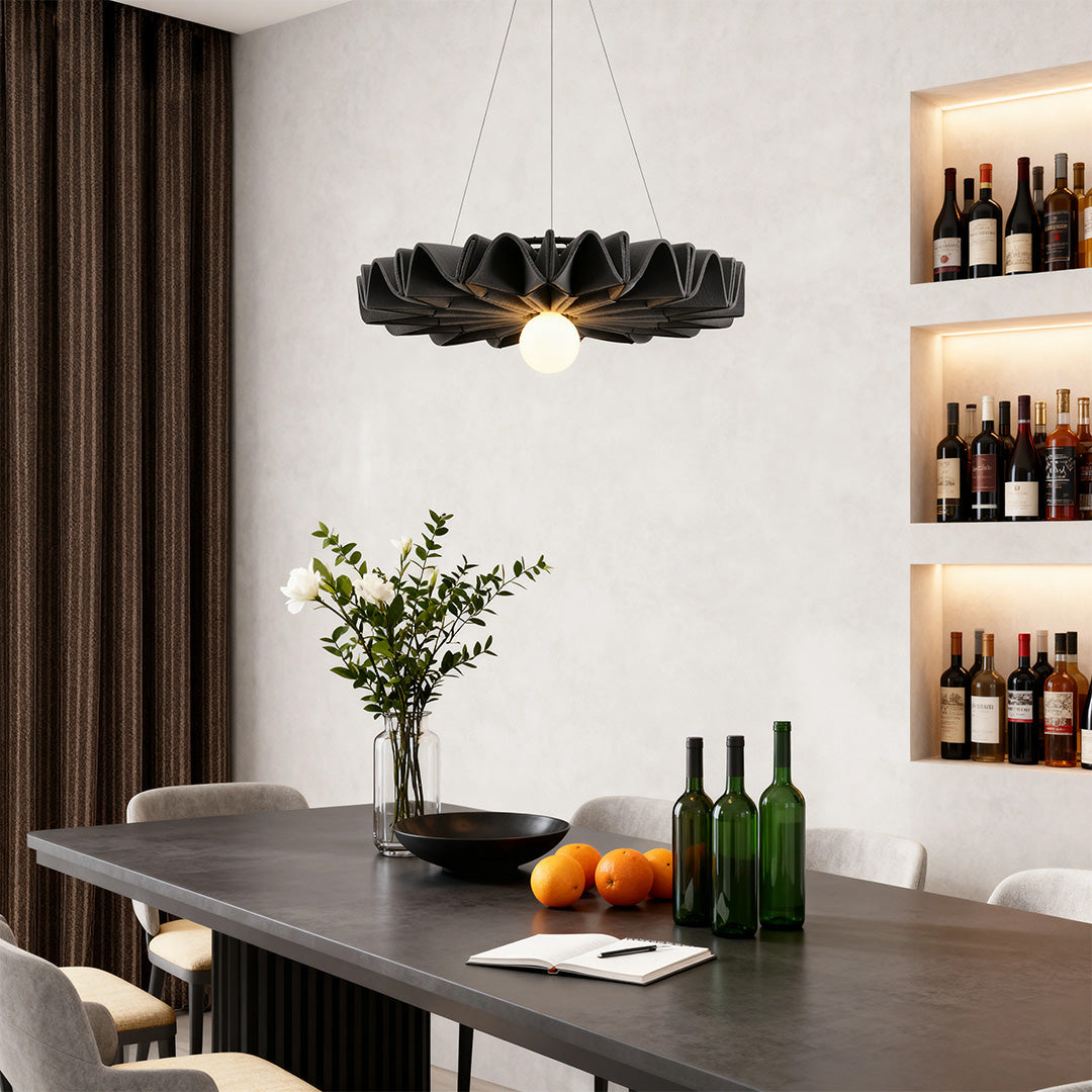Elegant black petal cloth chandelier illuminating a dining area with built-in wine shelving