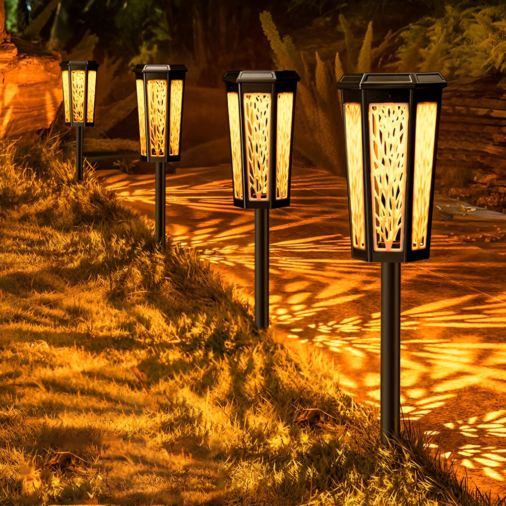Solar stake light casting colorful leaf patterns on the grass, creating a vibrant outdoor ambiance.