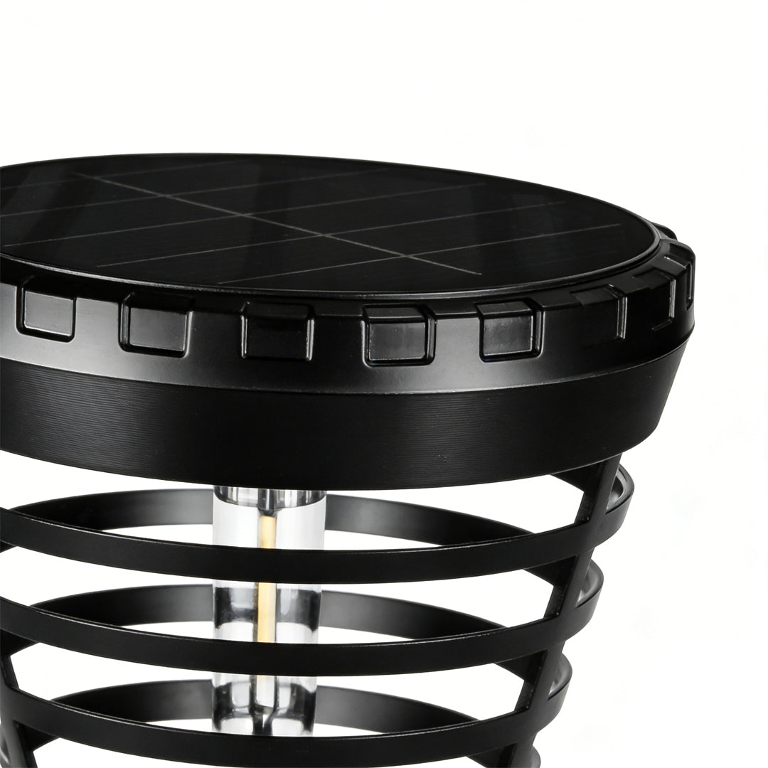 Solar torch light with a black finish, installed along a garden walkway.