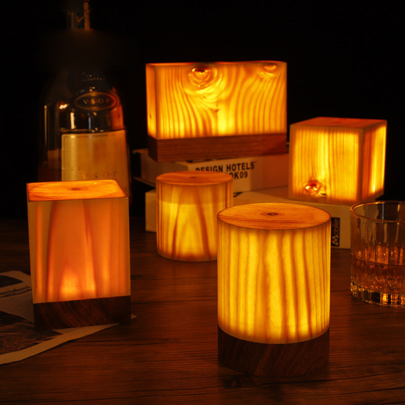 Square wood lamp enhancing a modern living room with rustic, ambient light.